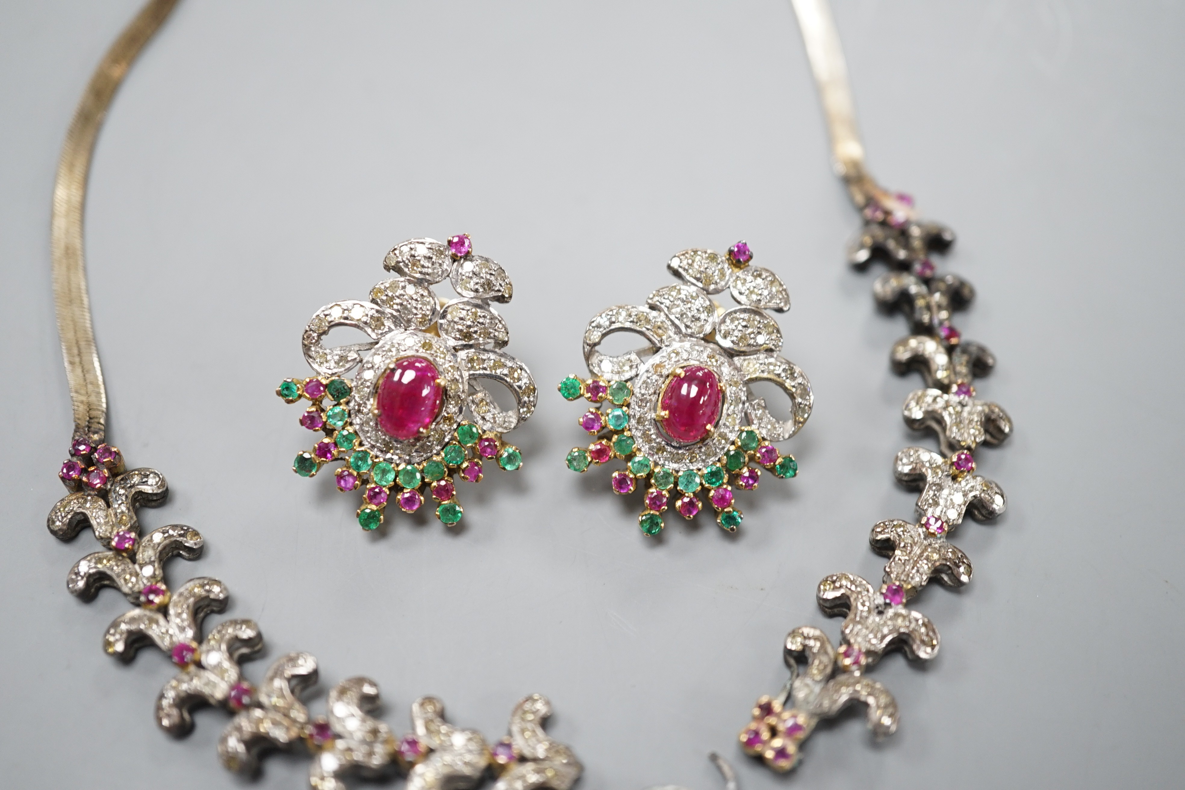 An Indian white and yellow metal, diamond, ruby and gem set necklace, 46cm and pair of matching earrings.